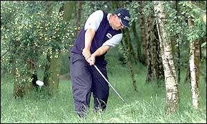 Defending champion Peter O'Malley finds trouble at the ninth but recovers to birdie the next two holes