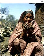 Muslim woman prays outside her burned home in Ahmedabad