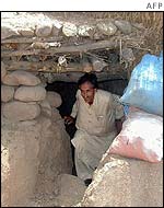 Kashmiri on the Pakistani side of the Line of Control emerges from his bomb shelter near the front line