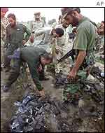 Pakistani soldiers examine the wreckage of the Indian spy plane
