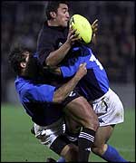 Two Italian tacklers try to get to grips with Daryl Gibson