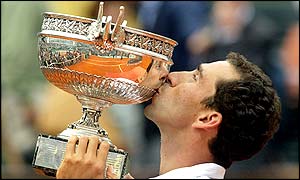 Costa kisses the winner's trophy