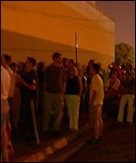 Soccer fans queue to watch match in a bar