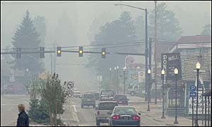 Smoke from forest fires fills the air in Woodland Park on the edge of Colorado caused street lights to come on Sunday