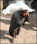 An Afghan man unloading aid