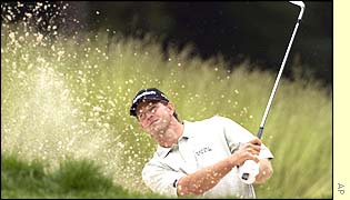 Retief Goosen, the defending champion, shoots a wild nine-over=par 79