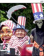 Protesters wear masks of Uncle Sam and President Gloria Arroyo