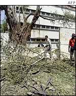 Staff inspect the damage at the US consulate