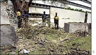Rescue workers examine damage caused by the blast