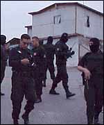 Mexican police prepare to raid a suspected drug dealer's home