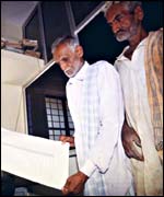 Villagers look at computerised land records