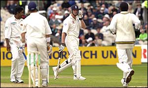 Flintoff glares at Alec Stewart after Stewart's shot hit the stumps to run Flintoff out