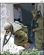 Israeli soldiers carry out a house search