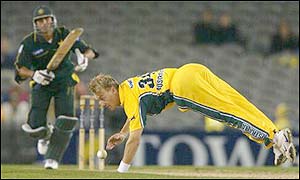 Andrew Bichel of Australia dives to stop a shot off Pakistan's Rashid Latif