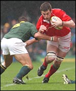 Michael Owen is tackled by South Africa skipper Bobby Skinstad