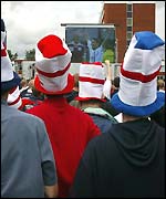 Fans watch the World Cup from the Old Trafford car park