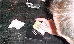 A man chops up lines of cocaine