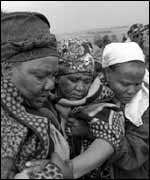 Relatives comfort the mother of a 21-year-old woman who died of Aids 