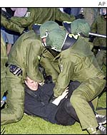 Police arrest an anti-US protester during George W Bush's visit to Berlin in May