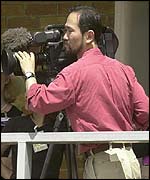 A television cameraman in the paddock