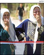 Palestinian women from Beit Safafa react to Jerusalem bombing