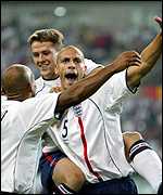 Ferdinand celebrates after scoring against Denmark
