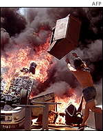 Rioters burned cars used as barricades during violent clashes in Genoa