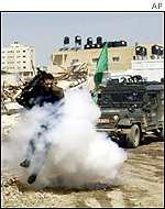 Israeli soldiers throw stun grenade at Reuters cameraman