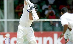 Mark Richardson is bowled by Windies bowler Adam Sanford