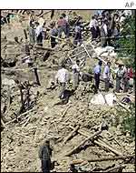 Villagers search through rubble in Abdareh