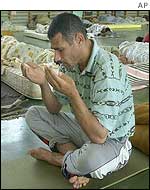 A would-be immigrant prays in Seville
