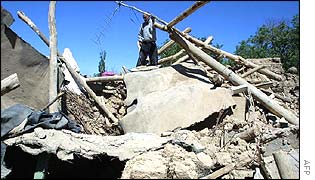 A man outside his wrecked home