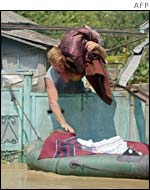 A man loads his belongings into a boat to save them in the village of Krasnaya 