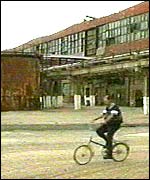 Man cycles through plant