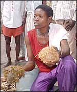 Environmental activist Fatima Amire shows the smoke bombs to villagers