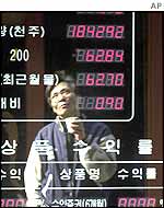 A man looks at a Korean stock market board