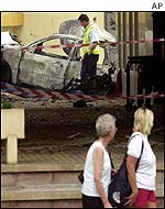 Tourists walk past scene of Fuegirola bomb