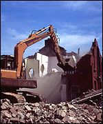 digger demolishes house