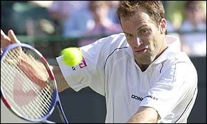 Greg Rusedski plays a backhand volley at the net