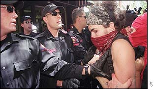 Calgary Police shove an anti-summit protester during a brief confrontation 