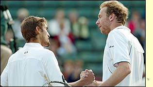 Winner Nicolas Escude shakes the hand of Marc Rosset as he reaches the third round 