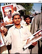 Boy with Bin Laden posters at Pakistani demonstration