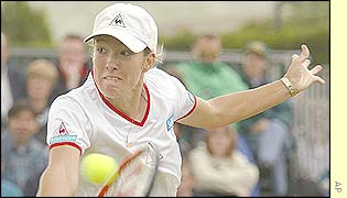 Justine Henin snatches the point through a quick backhand