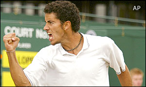 Brazil's Andre Sa punches the air on his way to defeating Spain's Feliciano Lopez