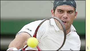 Mark Philippoussis concentrates on hitting a backhand