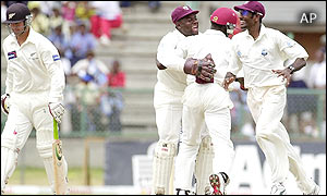 New Zealand's Nathan Astle walks off the field after being caught by Wavell Hinds