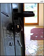 Smashed glass lies on the floor after Nato raid