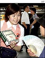 A woman sells a packed lunch at Tokyo station