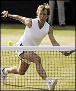 Martina Navratilova stretches for a forehand volley 