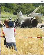 Journalists film the wreckage